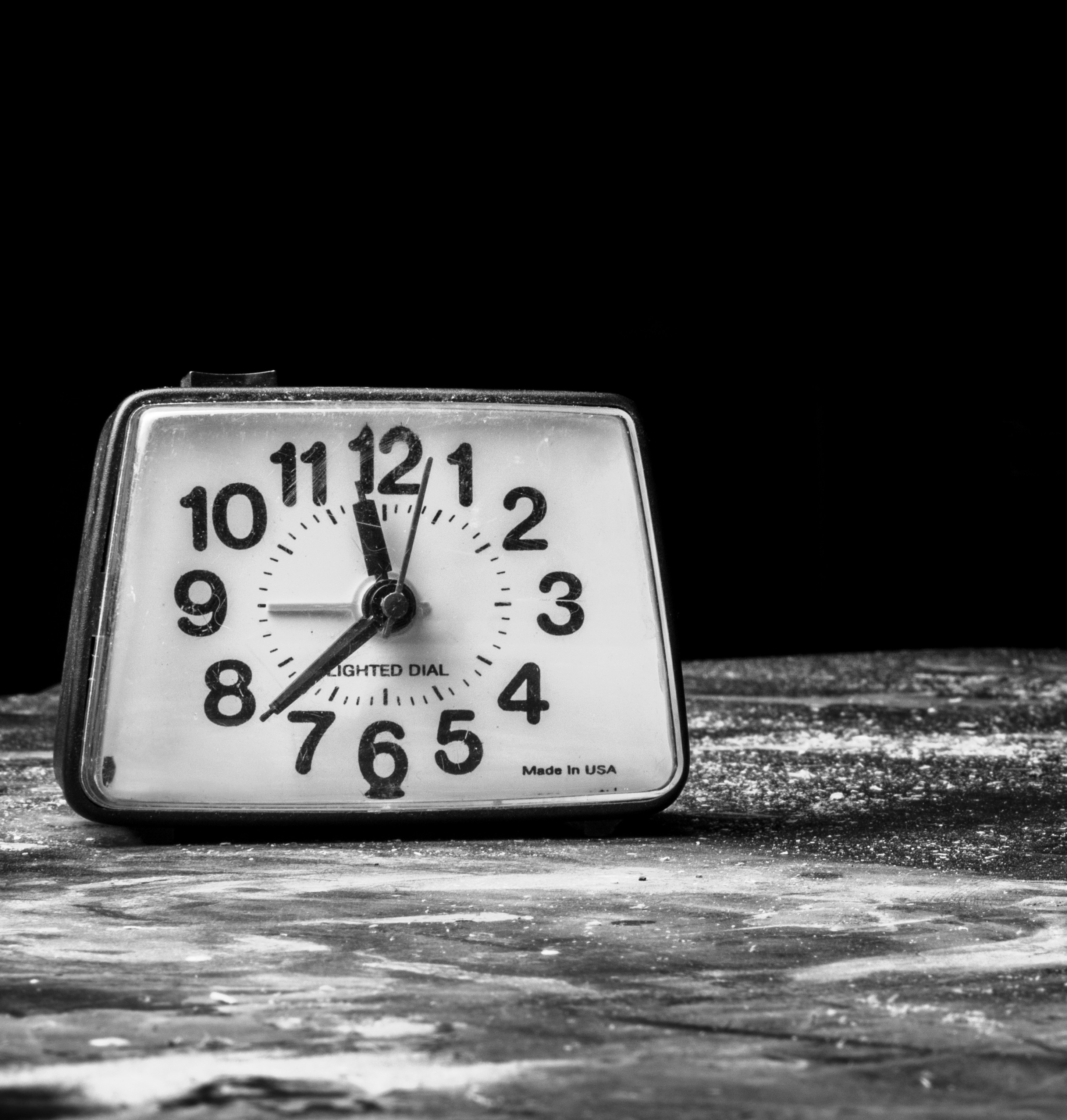 Ticking clock on grey surface