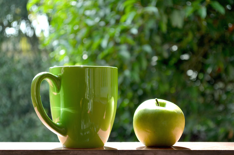 Green mug and apple