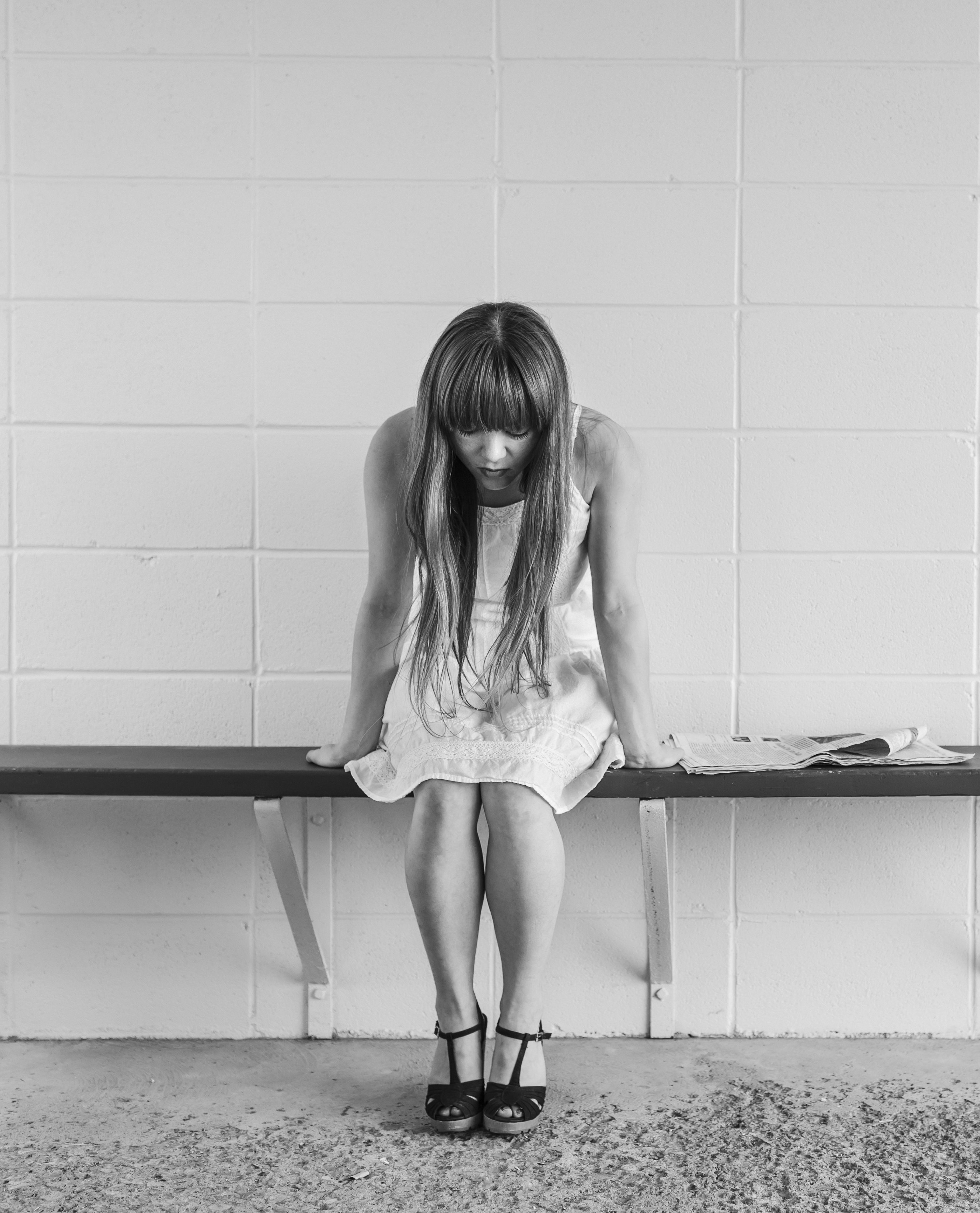 Girl sitting on bench looking down