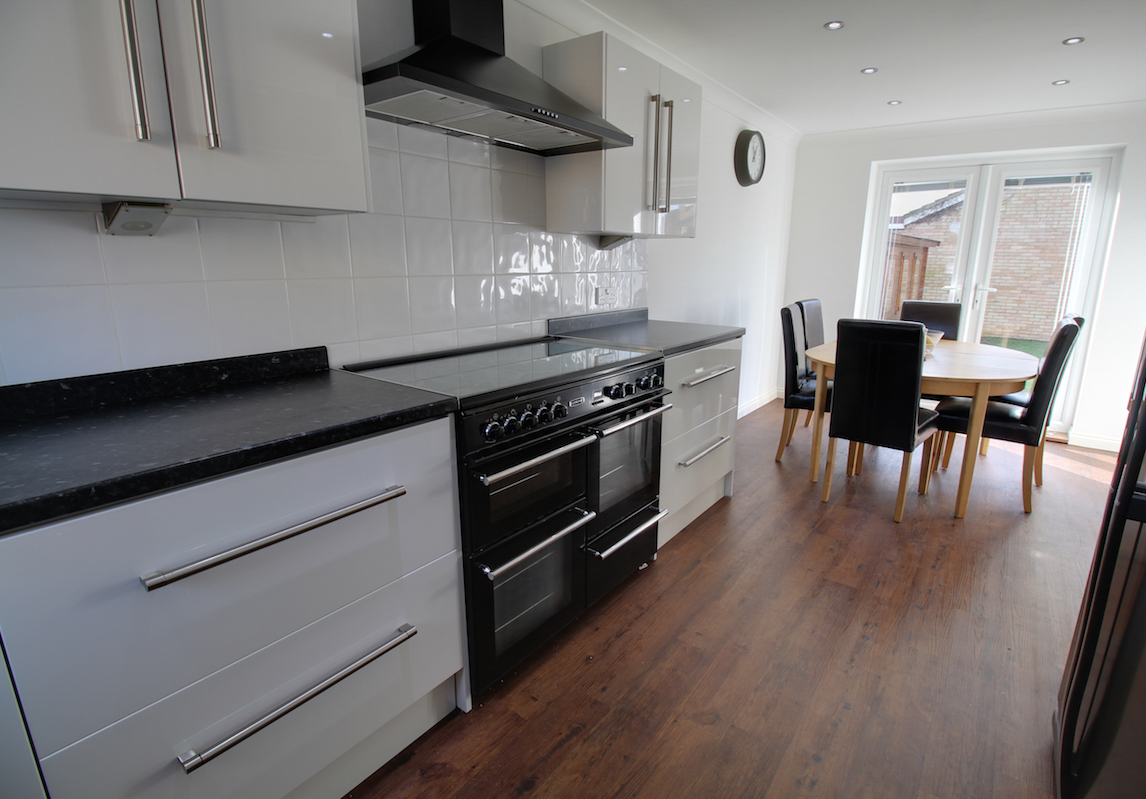 Kitchen with contrasting black surfaces and white cabinets