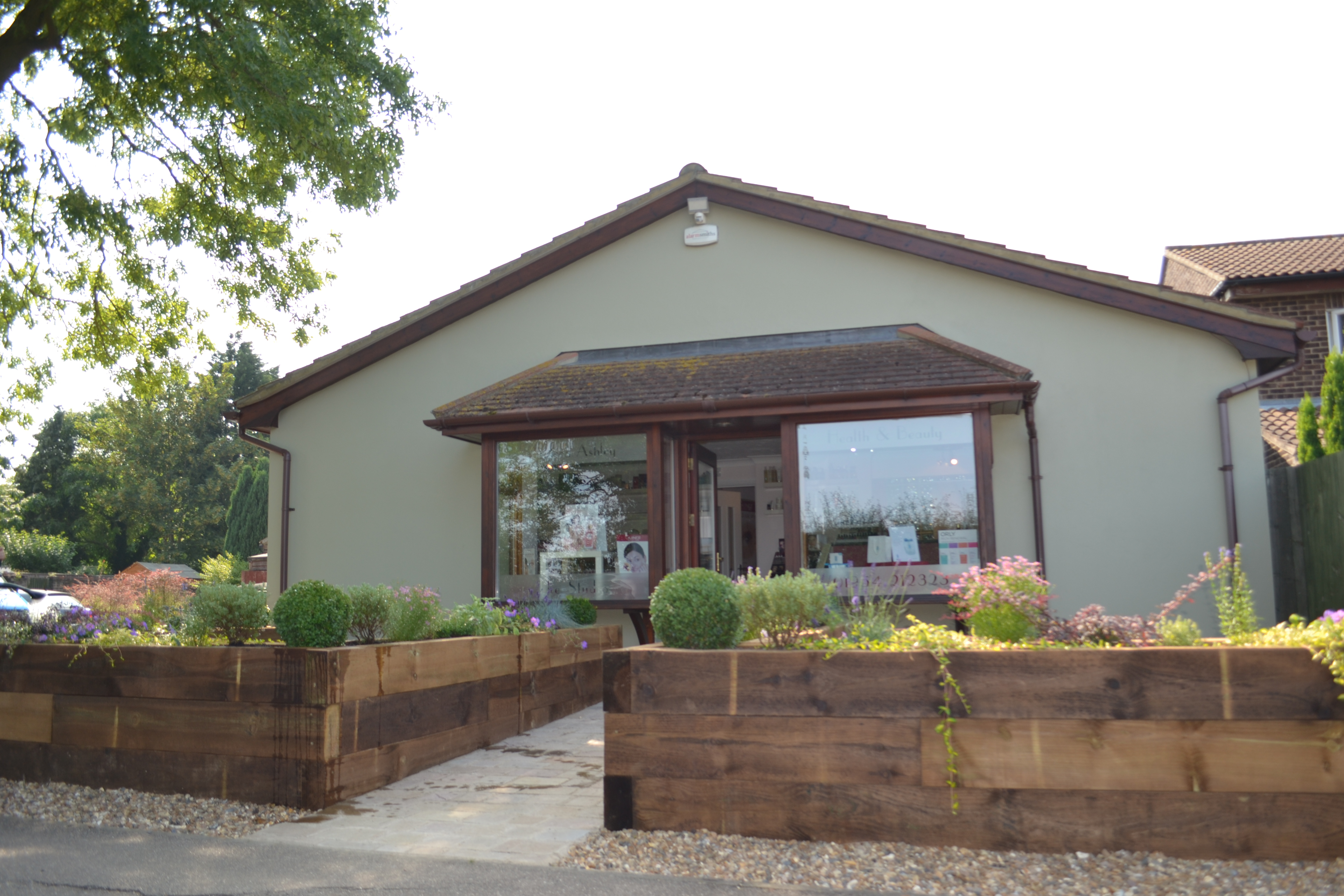 Exterior of beauty salon with flower beds