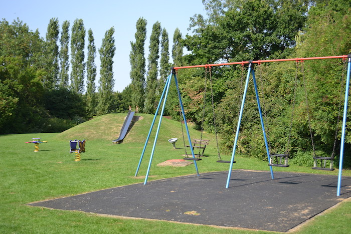 Children's play area with swings and slides