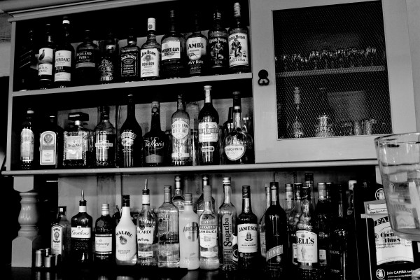 Drinks cabinet displaying lots of bottles