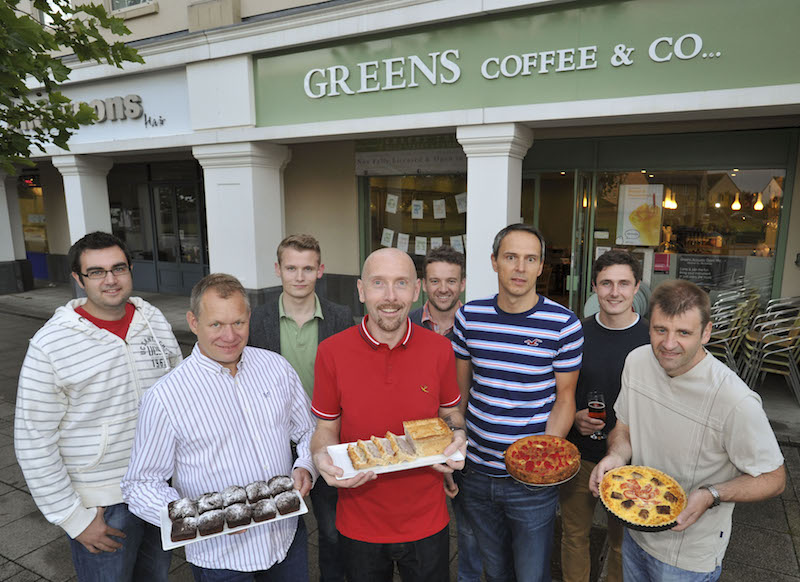 Men holding baked items