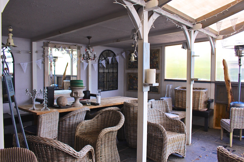 Restaurant conservatory with wicker chairs and tables