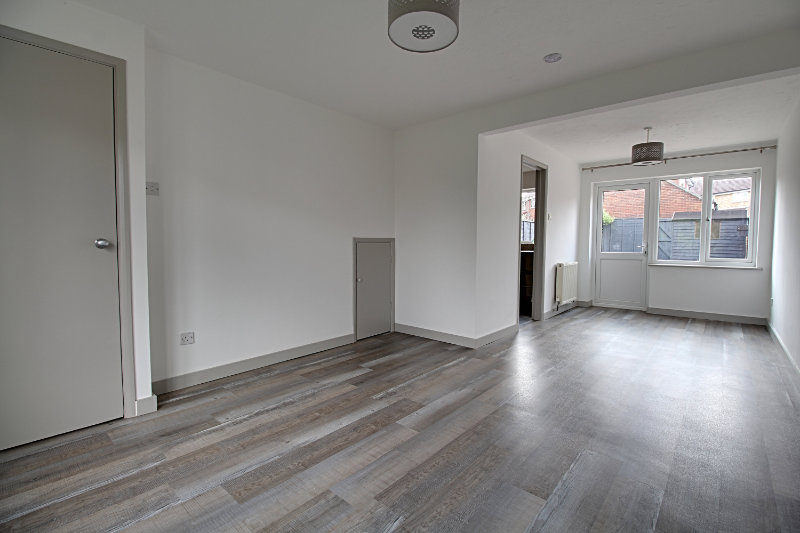 Should I leave my property unfurnished? Empty lounge with curtains drawn